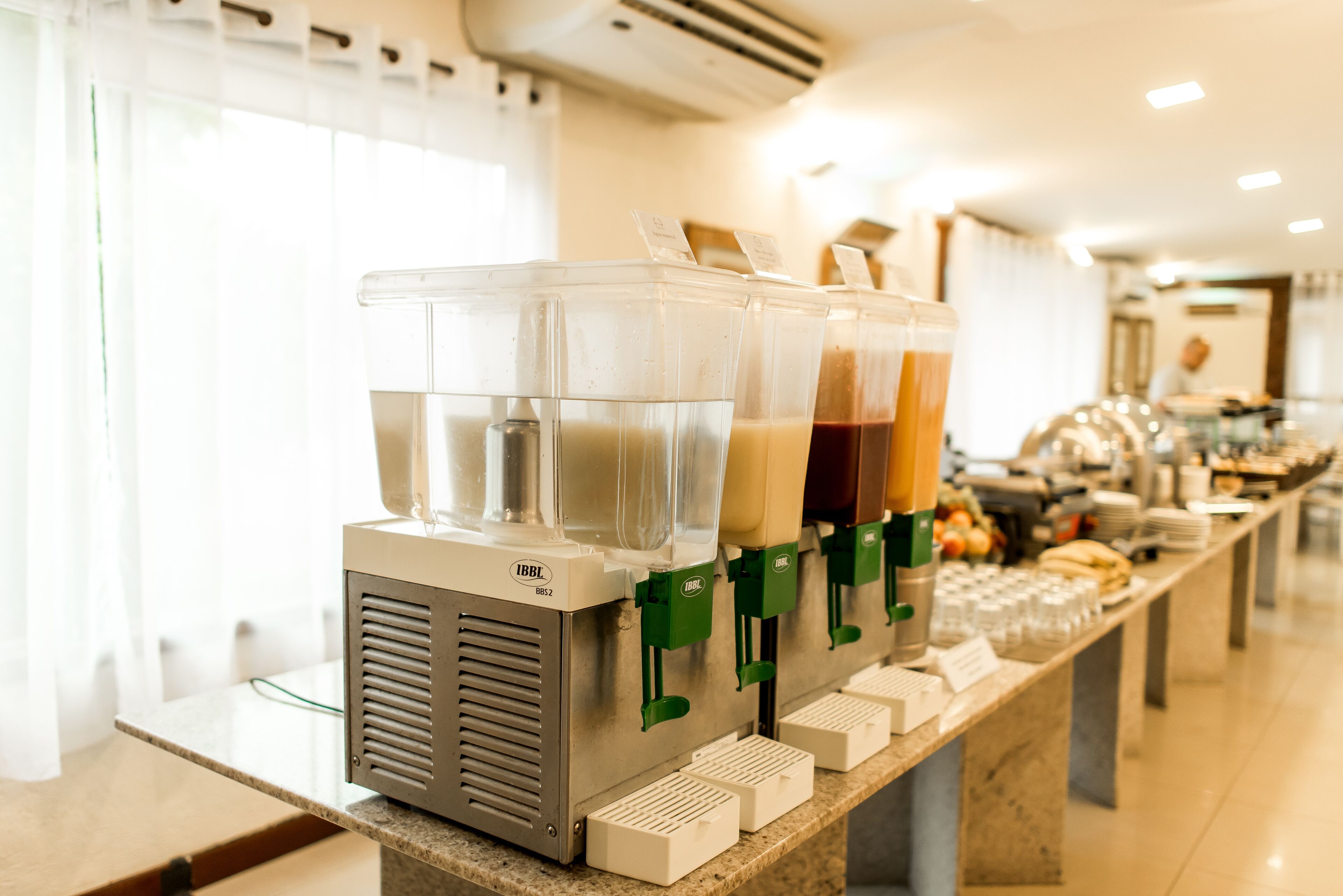 A beverage dispenser with multiple containers and a menu sign.
