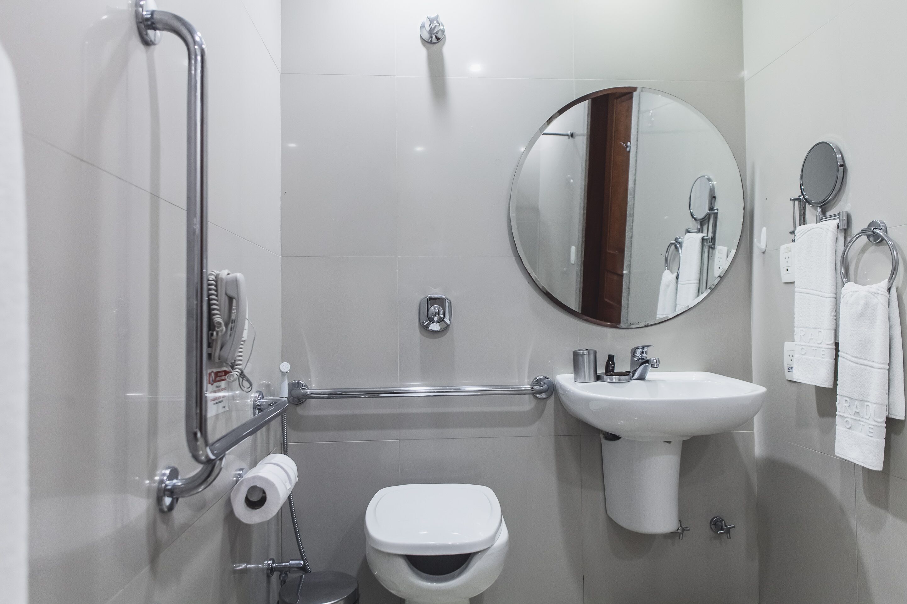 A modern bathroom with a toilet, sink, and shower.