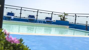 Seasonal outdoor pool, open 8:00 AM to 8 PM, pool loungers