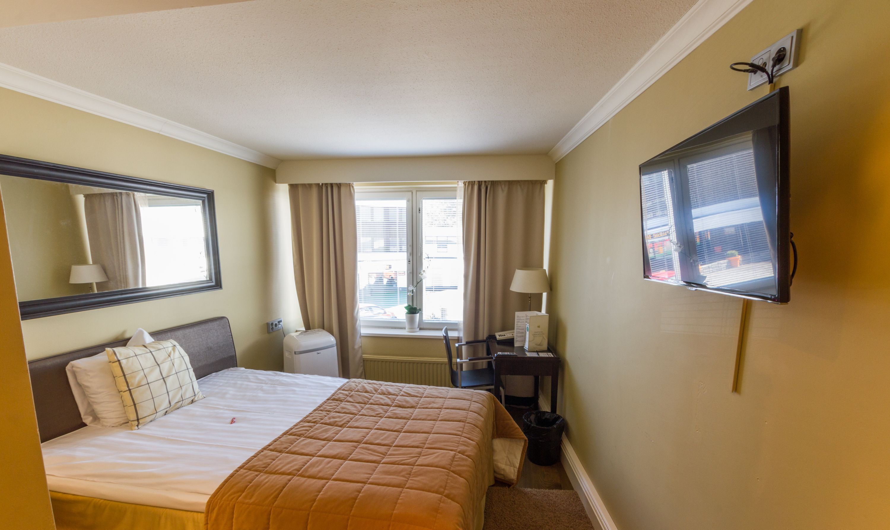 Premium bedding, desk, laptop workspace, blackout curtains