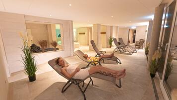 Relax in a serene space with reclining chairs and lush greenery.
