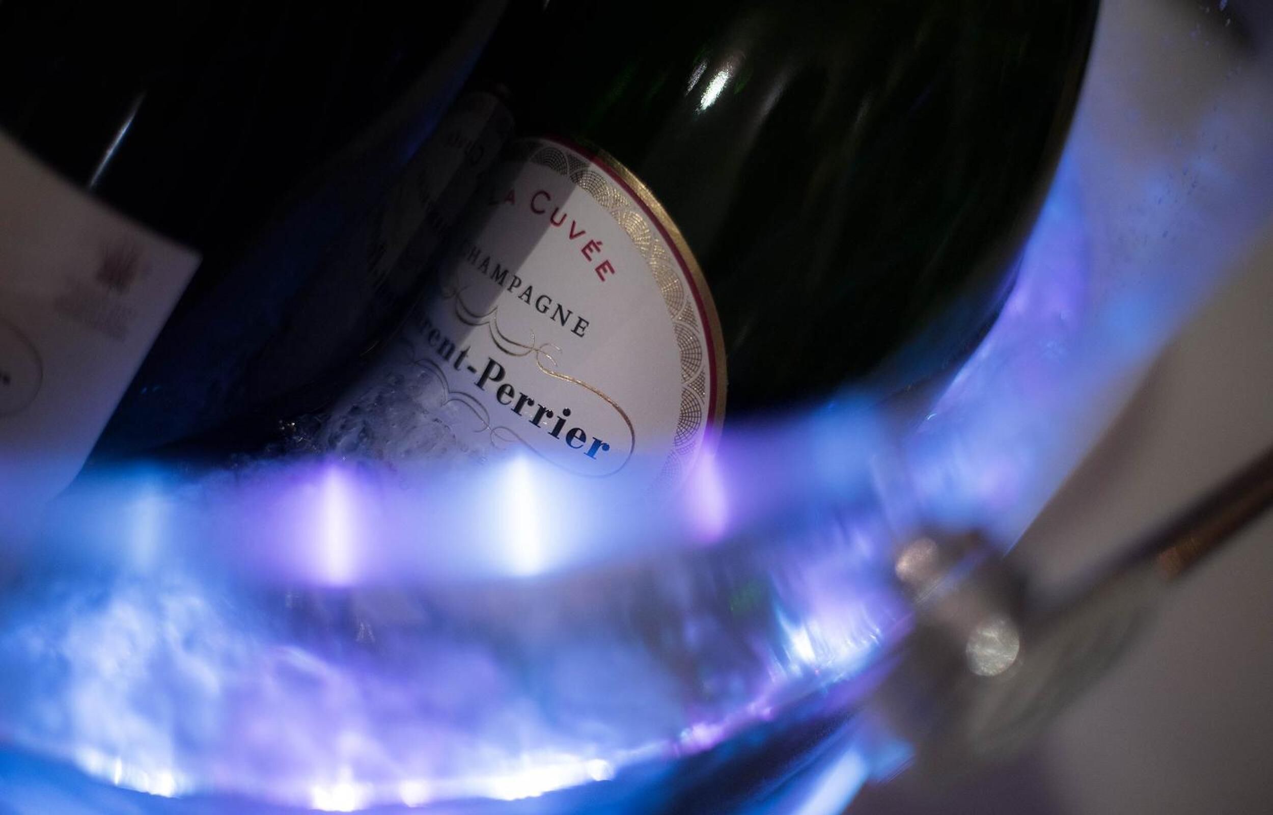 A bottle of champagne with a label that reads "Cuvée Champagne."