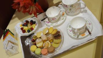 A tray with tea service and assorted pastries.