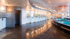 A spacious indoor swimming pool area with a curved ceiling and a series of lockers along the wall. - Mayhills Resort (Jeongseon)