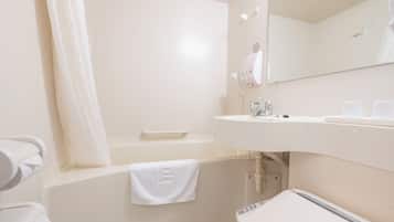 A modern bathroom with a bathtub, a sink, and a mirror.