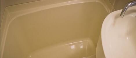 A bathroom with a bathtub and a sink.