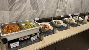 A buffet counter with various dishes, including stir-fried octopus and pan-fried zucchini, labeled in Korean. - Toyoko Inn Busan Seo-myeon (Busan)