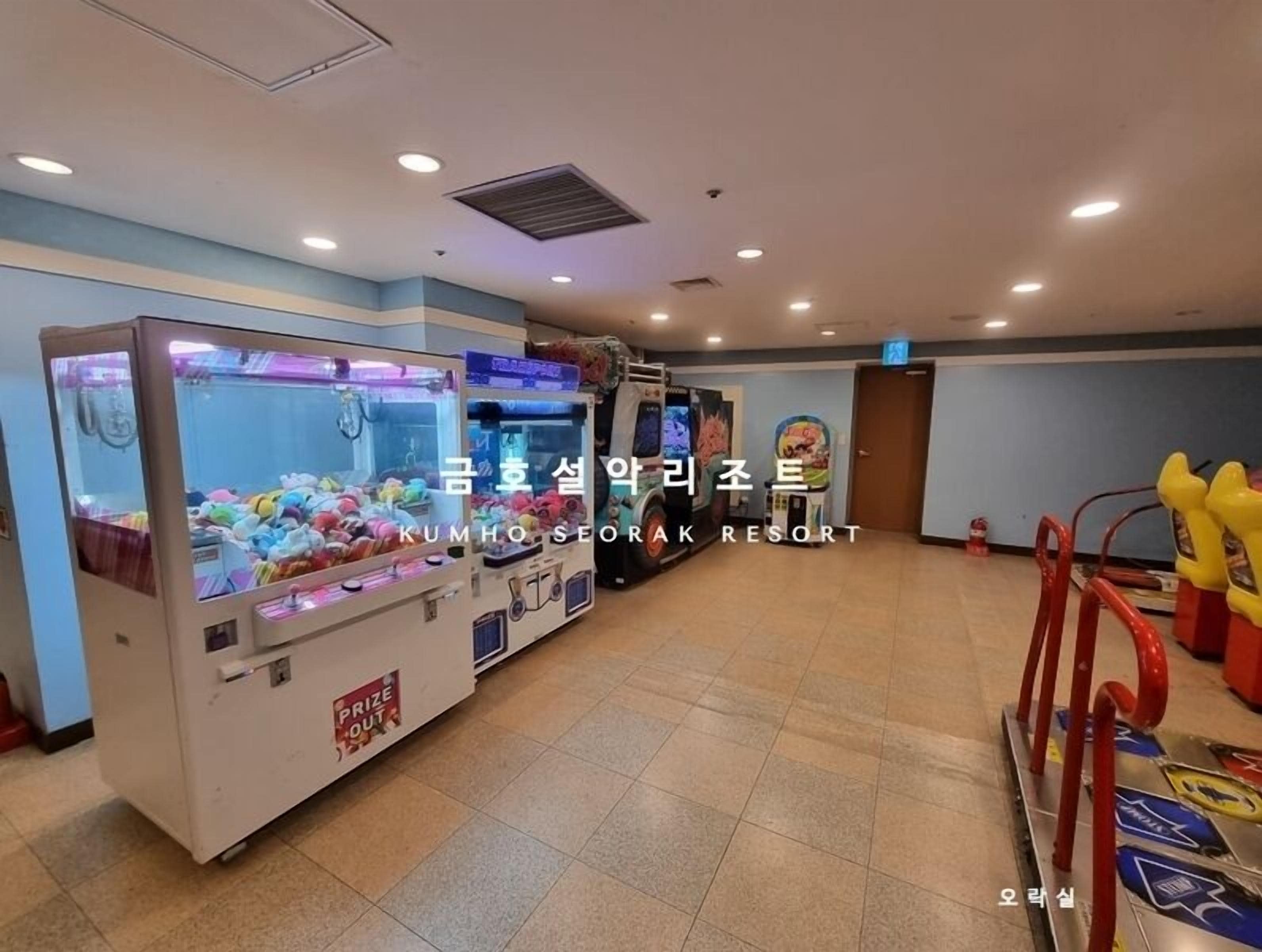 A spacious room with multiple claw machines and a few arcade games.