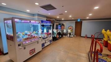 A spacious room with multiple claw machines and a few arcade games.