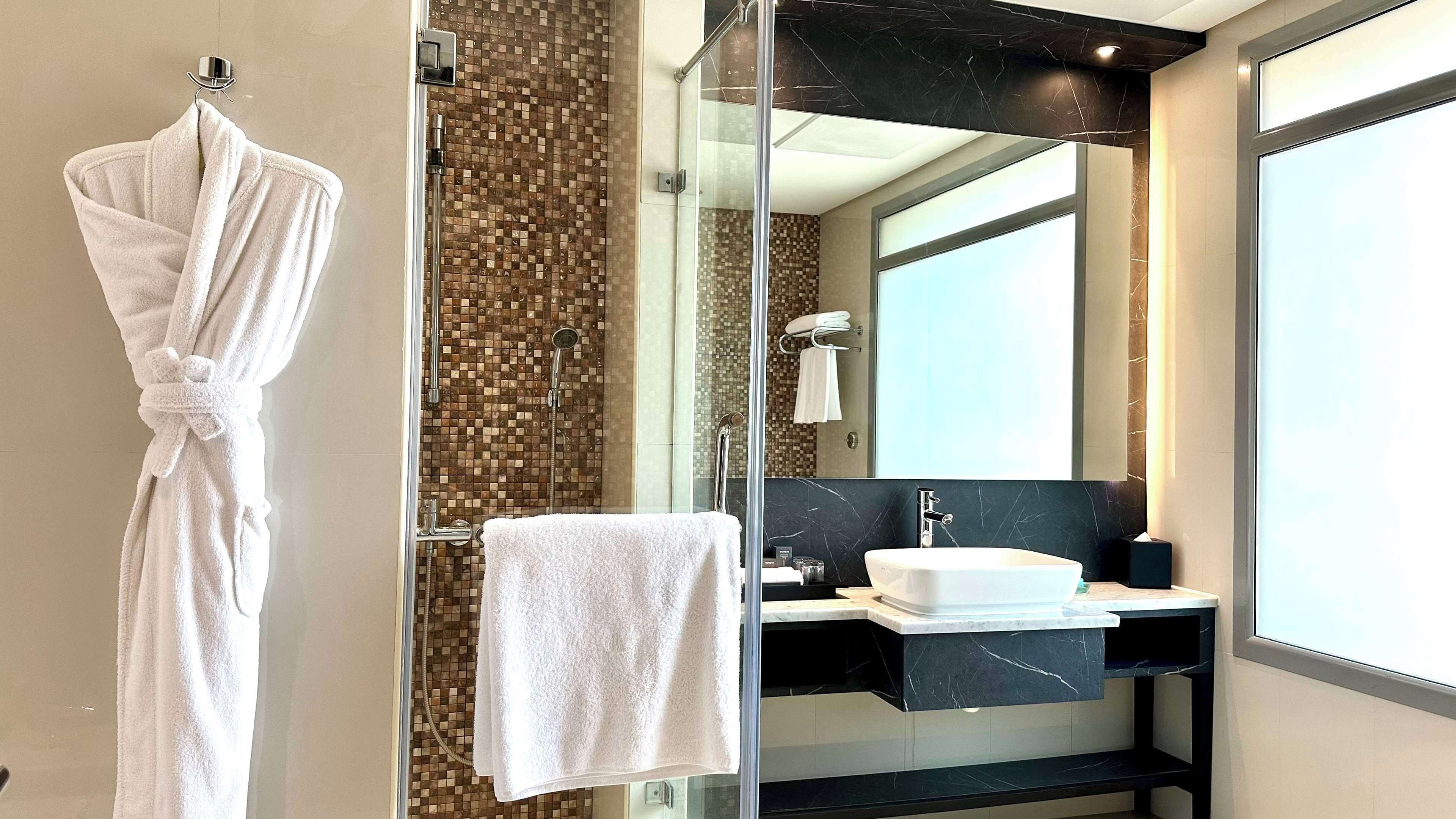 separate bathtub and shower, hair dryer, bathrobes, slippers