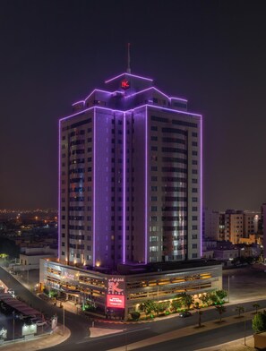 A high-rise hotel with a prominent 'K' logo, multiple floors, and a modern design. - The K Hotel, WorldHotels Distinctive (Manama)