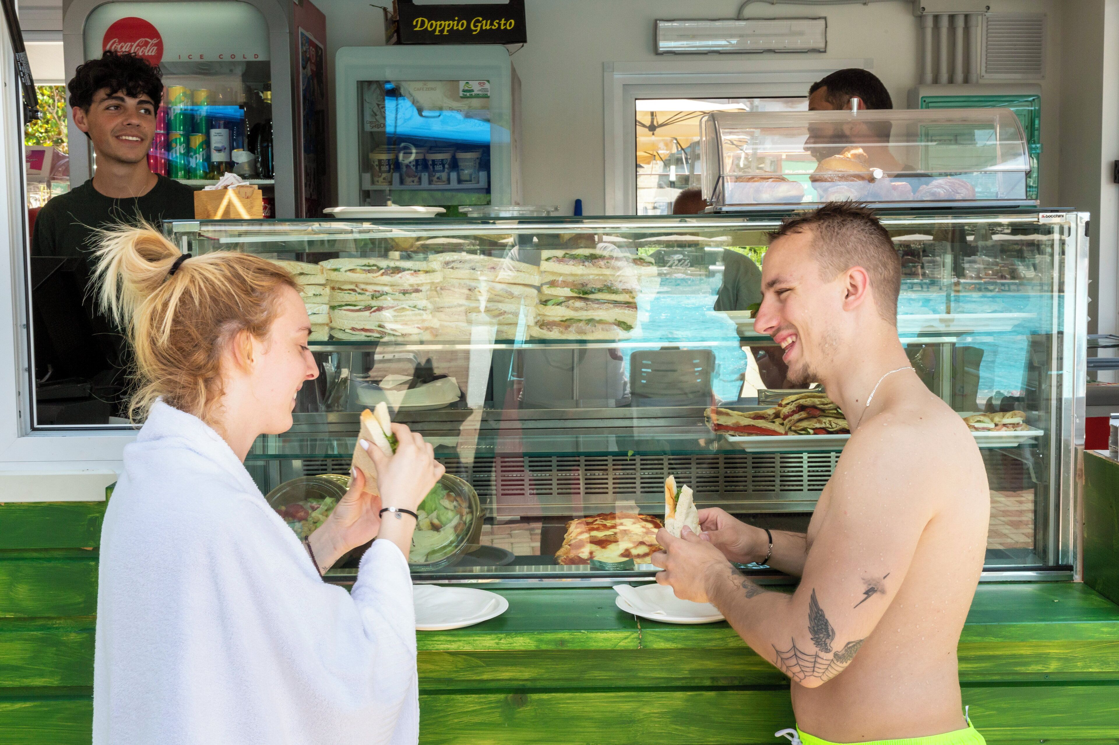 A sandwich shop with a glass display case filled with sandwiches.