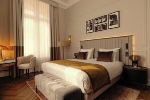 A hotel room with a large bed, a bedside table, a chair, and a lamp. - The Manor Amsterdam (Amsterdam)