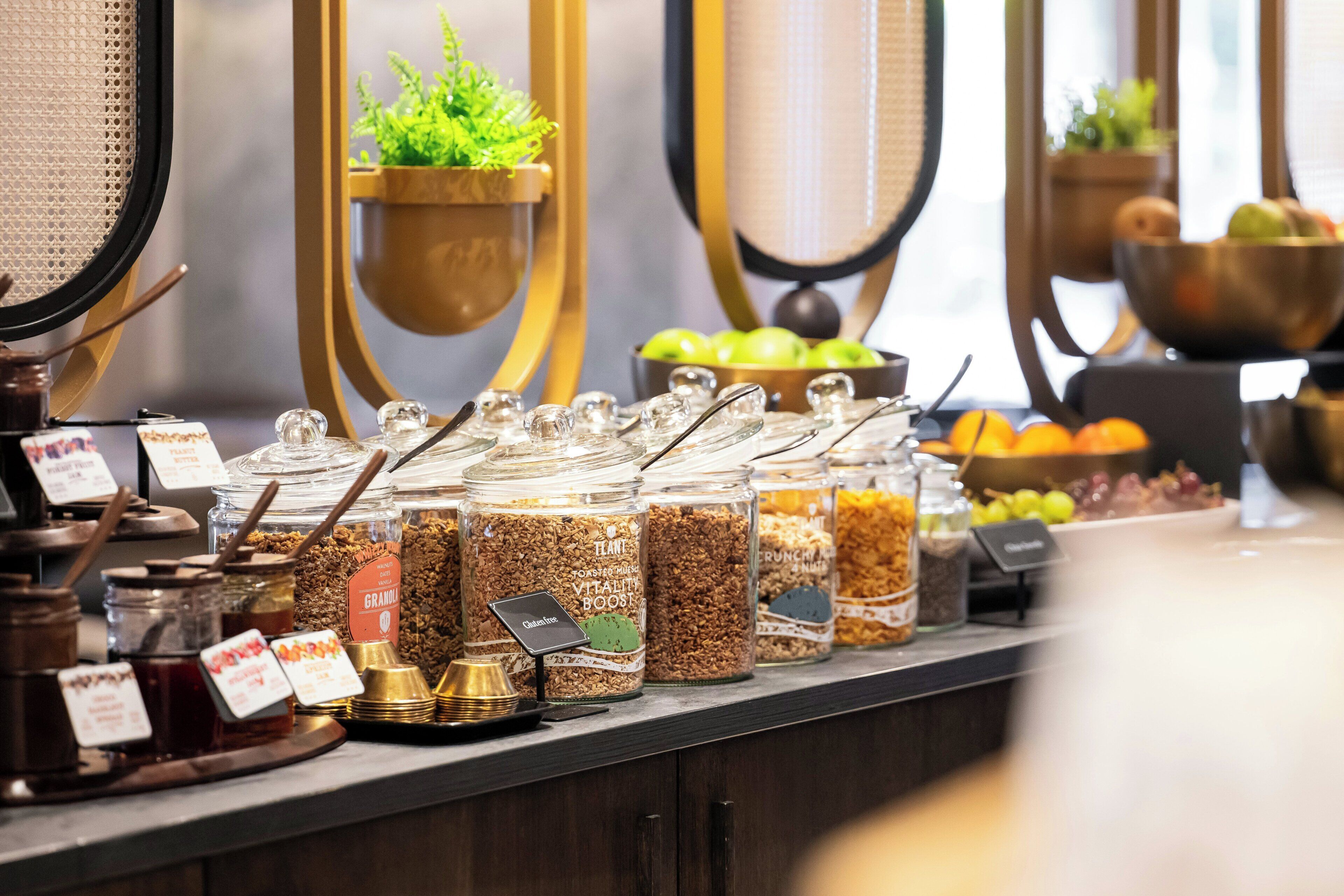 Un mostrador de buffet con distintos alimentos y recipientes.
