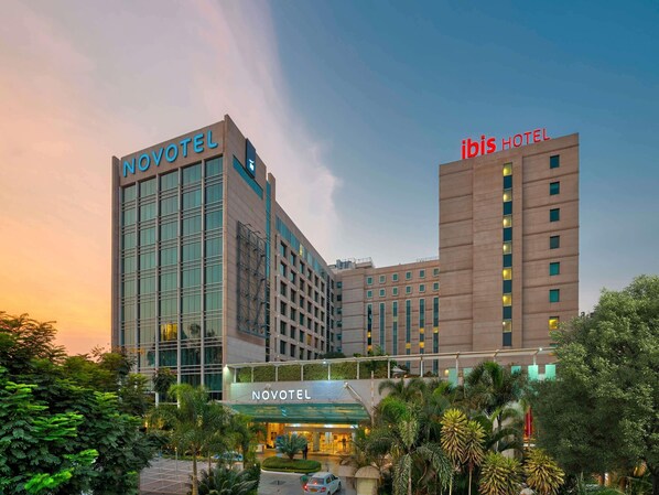 A hotel with a modern facade, multiple floors, and a prominent 'NOVOTEL' sign.