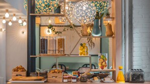 A kitchen counter with various food items, jars, and a toaster. - ibis Styles Paris Montmartre Nord (Paris)