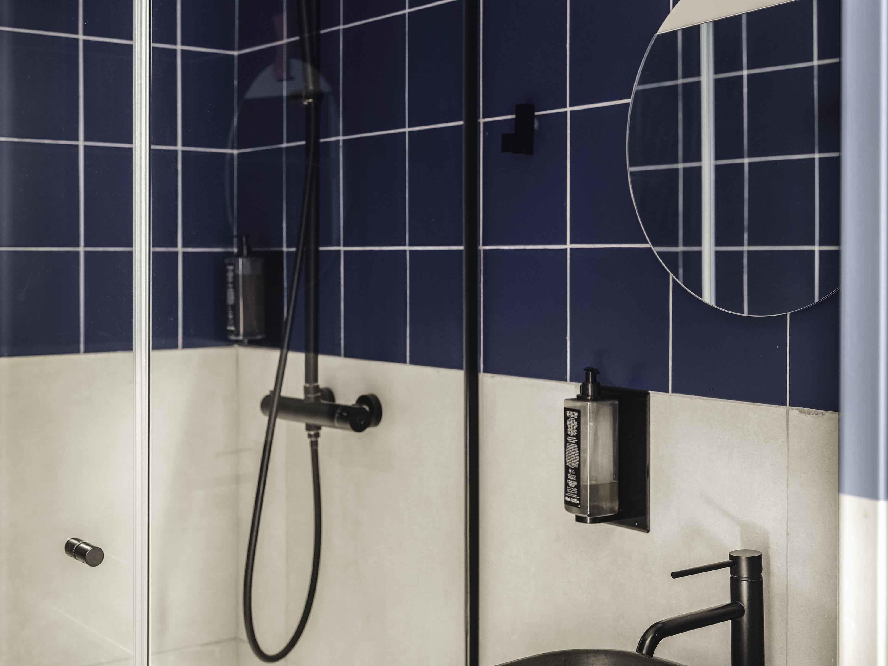 A bathroom with a shower, a toilet, and a sink.