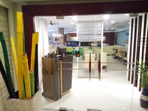 A reception area with a counter, a glass partition, and a sign offering a discount. - Discovery Hotel (Phnom Penh)