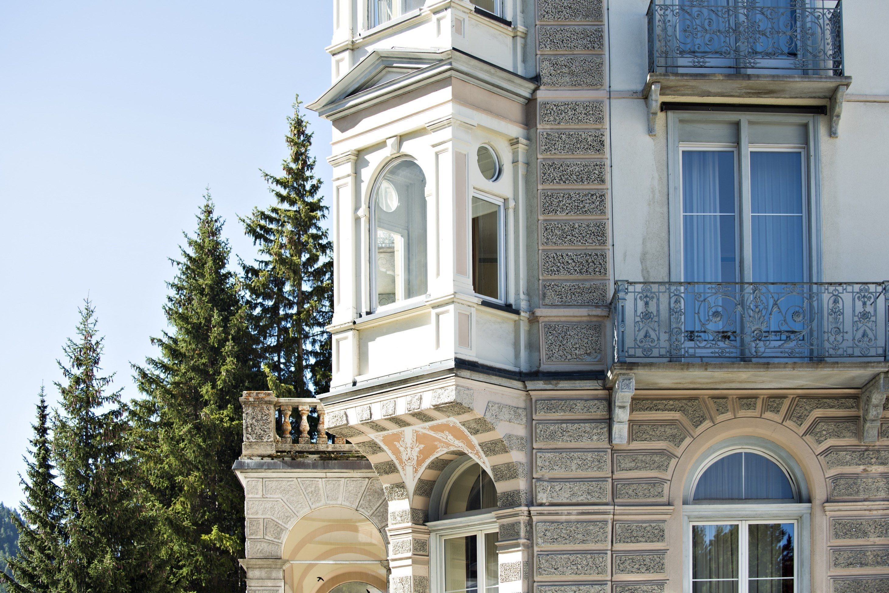 A historic building with ornate architectural details, including arched windows and decorative stonework.