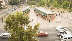 A busy urban street with a central plaza, buildings, and trees. - Jazz Apartments Luxury Suites (Bogotá)