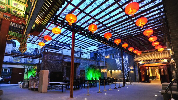 An outdoor courtyard with traditional architecture, lanterns, and a fountain. - Beijing Traditional View Hotel (Beijing)