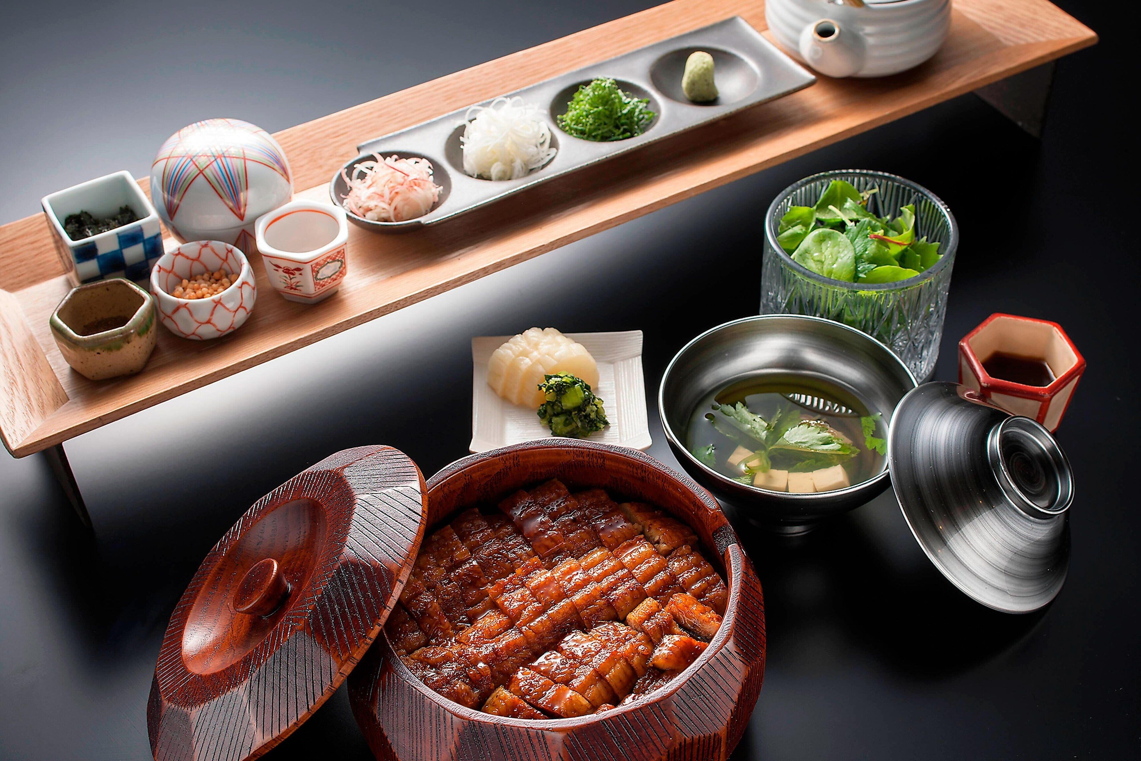 A traditional Japanese meal setup with various dishes and utensils.