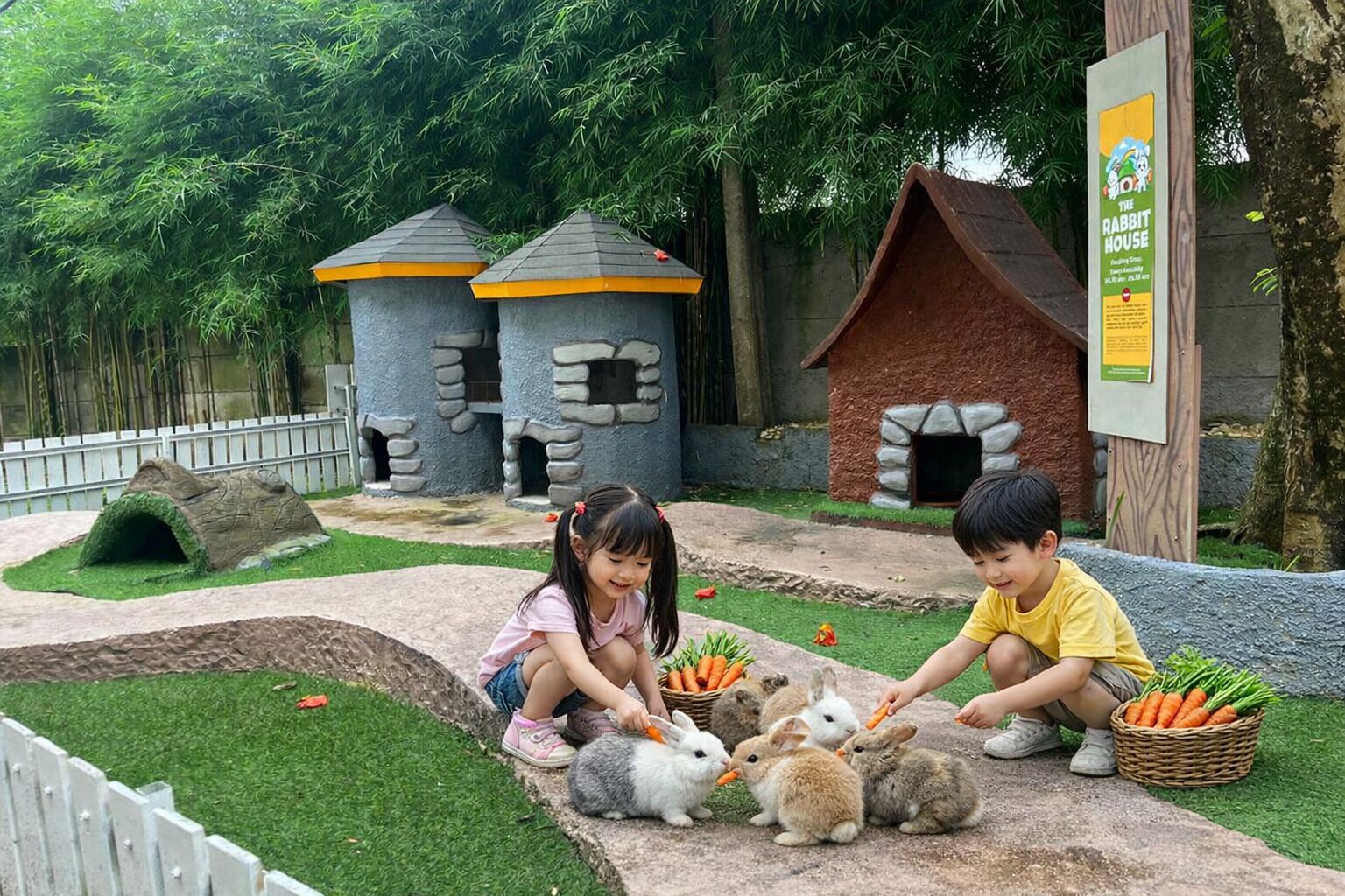 A children's play area with rabbit-themed structures and a sign for 'The Rabbit House.'