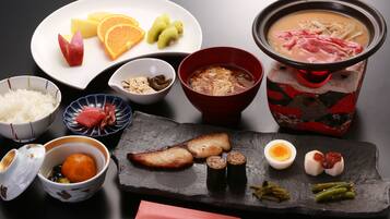 A variety of Japanese dishes including sushi, tempura, and a hot pot.