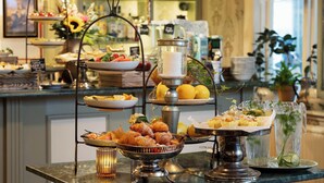 A buffet setup with various food items and a candle centerpiece. - Strandflickornas Havshotell (Lysekil)
