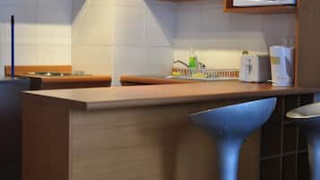 Fridge, microwave, coffee/tea maker, cookware/dishes/utensils