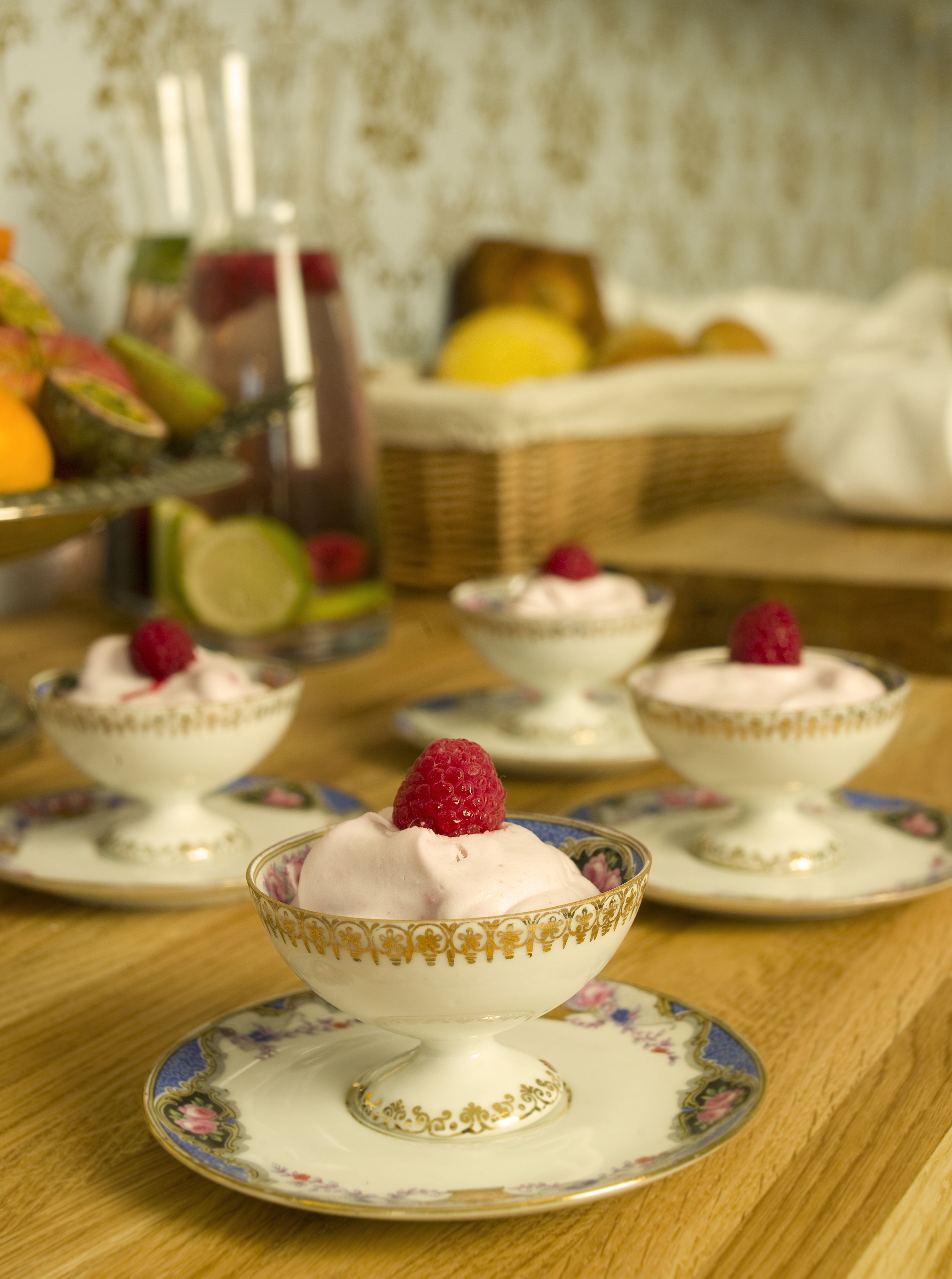 Three bowls of dessert on a table with a floral pattern.