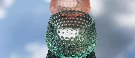 A row of textured glass candle holders in various colors.