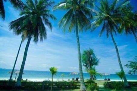 On the beach, white sand, sun loungers, beach umbrellas
