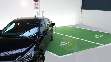 A parking space with a green floor and white parking lines.