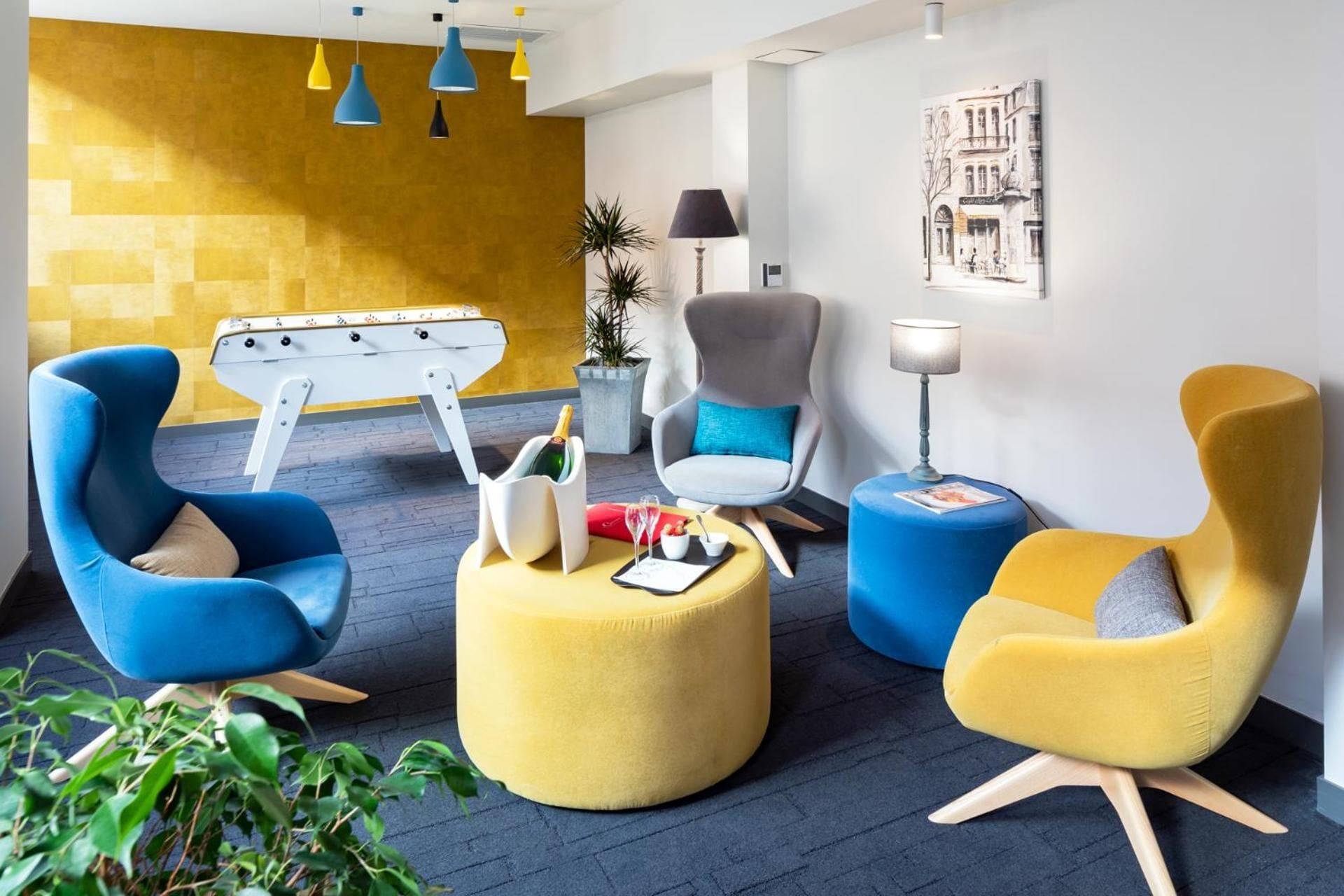 A modern lounge area with a yellow wall, a pool table, and contemporary seating.