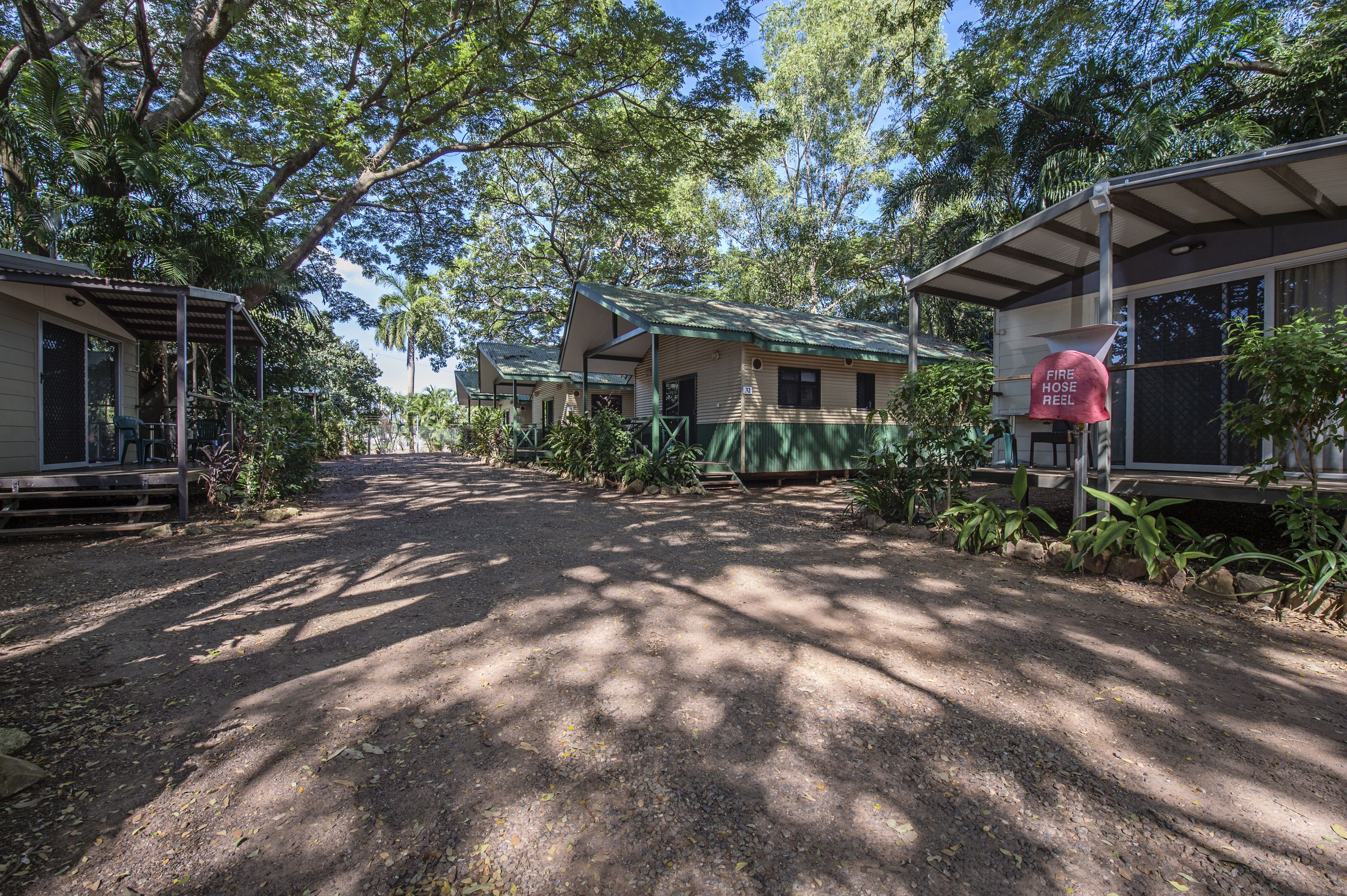 A campground with cabins and a fire hose reel.