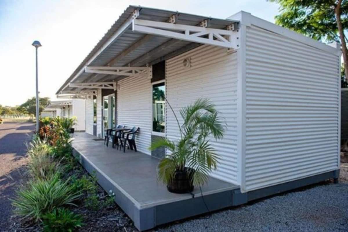 A modern, single-story building with a flat roof and a covered porch area.
