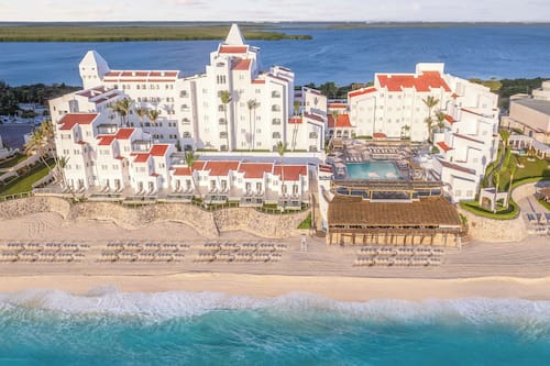 On the beach, white sand, beach umbrellas, beach towels