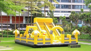 An inflatable play structure with slides and tunnels in a park area. - Crowne Plaza Guangzhou Huadu by IHG (Guangzhou)