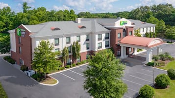 A Holiday Inn Express hotel with a parking lot, a covered entrance, and a brick facade.