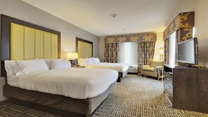 A hotel room with two beds, a desk, a chair, a television, and a patterned carpet. - Holiday Inn Express & Suites Gonzales by IHG (Gonzales)