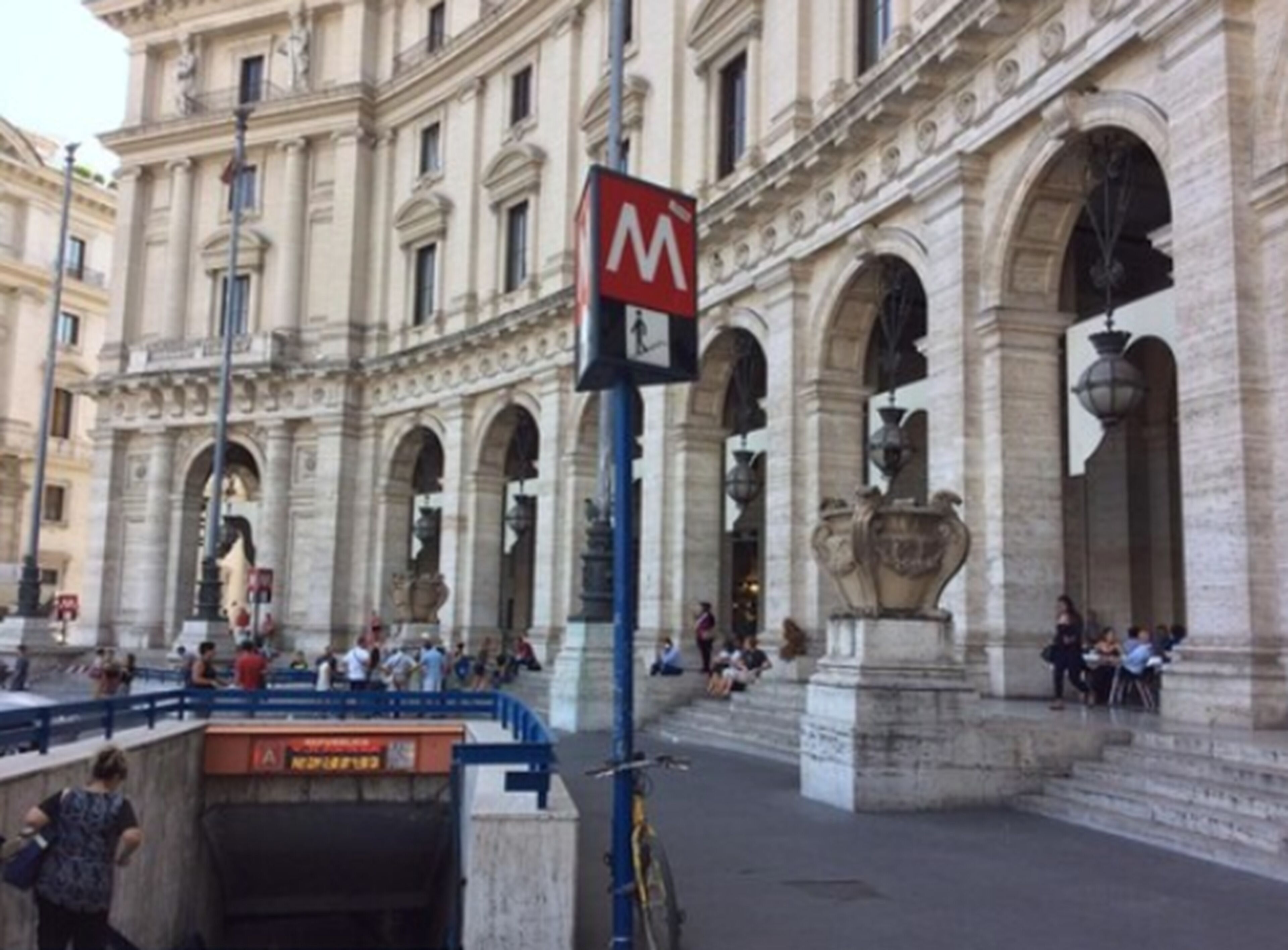 A historic building with classical architecture, including arches and statues.