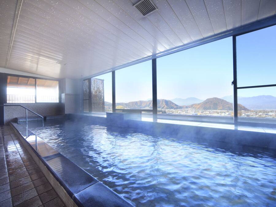A hot spring bath with a view of mountains.