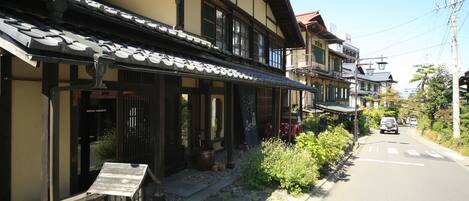 A traditional Japanese building with a tiled roof and wooden beams.