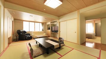 Une pièce de style japonais traditionnel, avec un sol recouvert de tatamis, une table basse, un canapé et un téléviseur.