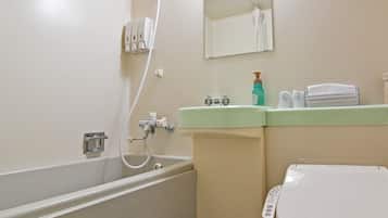 A bathroom with a bathtub, toilet, sink, and a mirror.