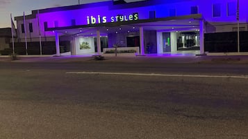 Enter the ibis styles through a sheltered walkway, featuring a clean, contemporary design and large windows.