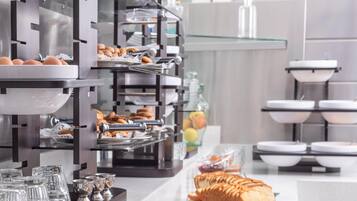 A buffet setup with various food items and glassware.