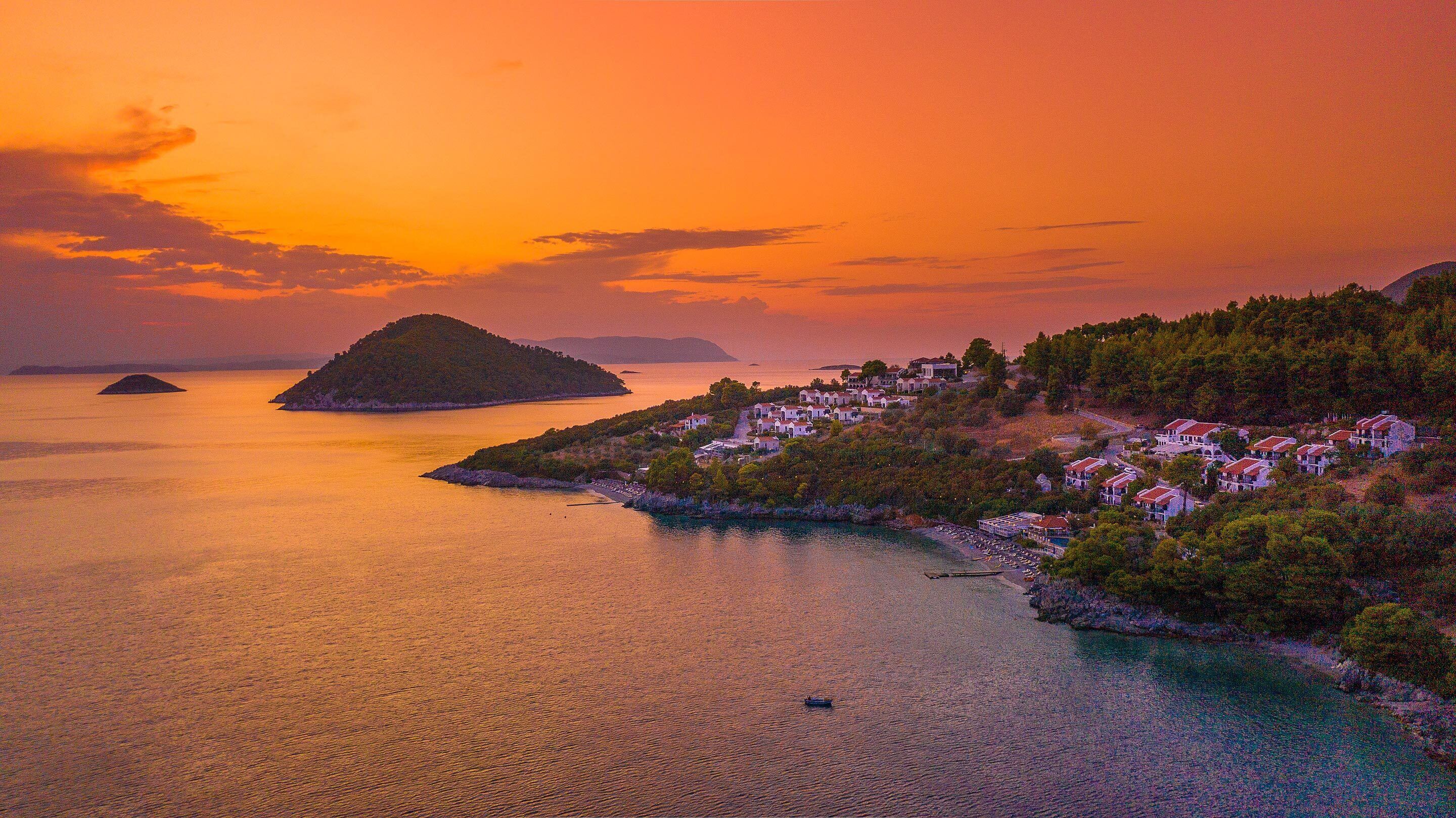 A coastal village with houses on a hillside overlooking the sea.