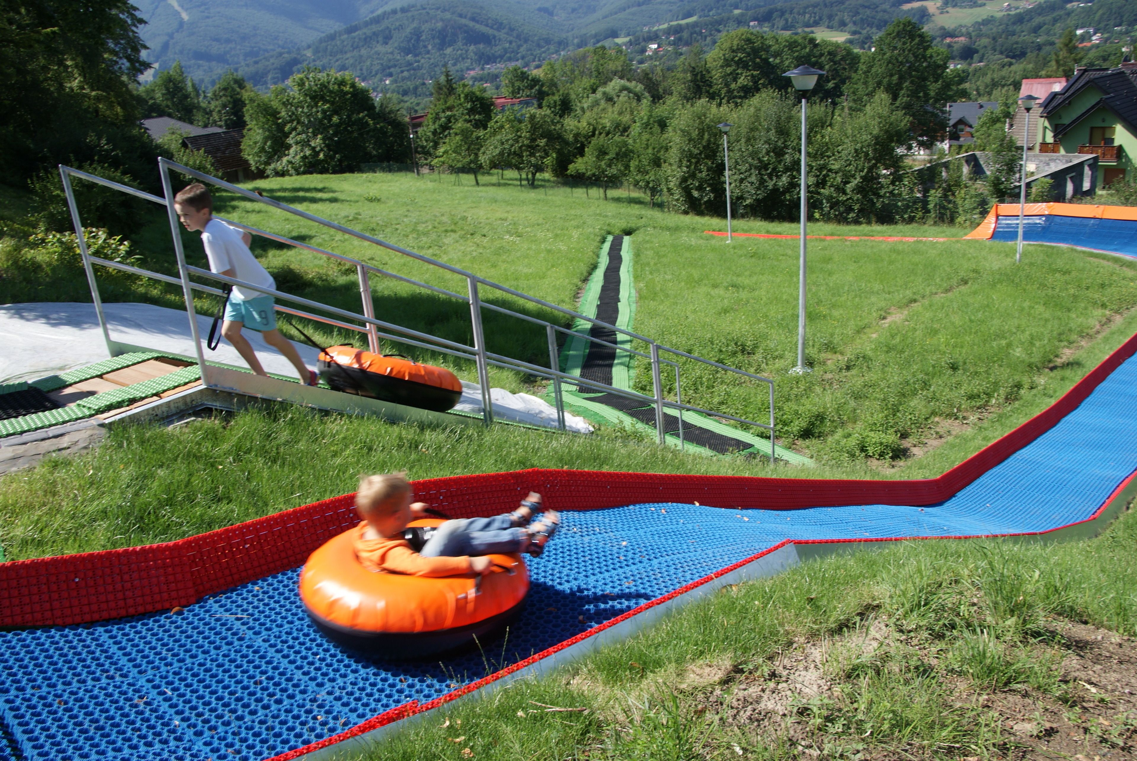 A playground with a slide and a climbing structure.
